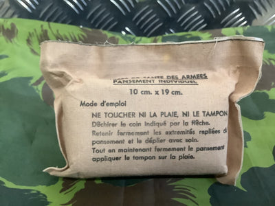 Military bandage package with instructions on a camouflage background