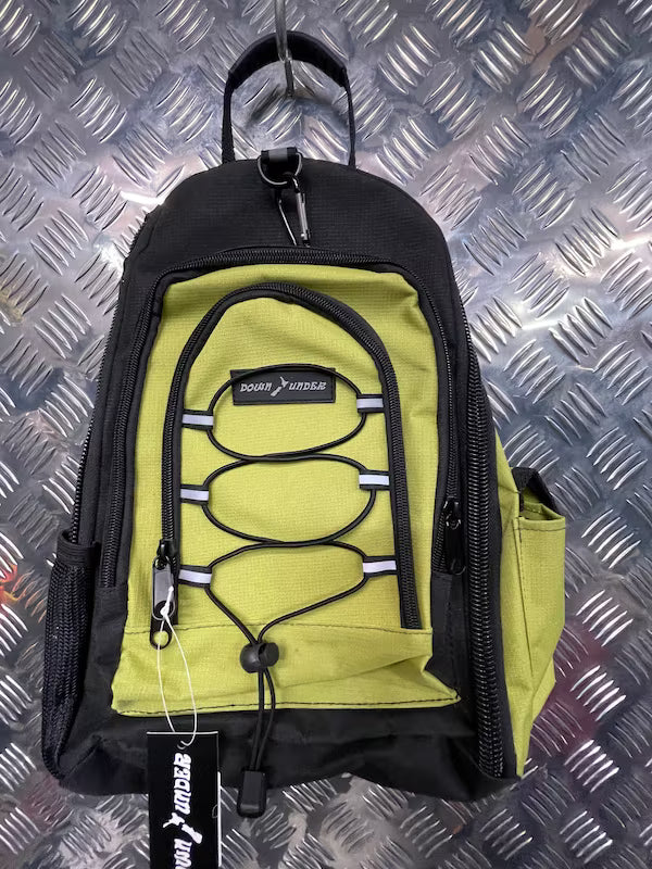 Green and black backpack with a visible brand tag on a metallic surface