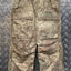 Camouflage military pants on a metallic surface