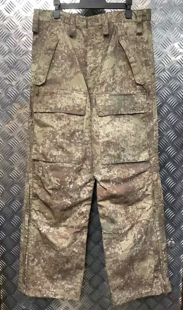 Camouflage military pants on a metallic surface
