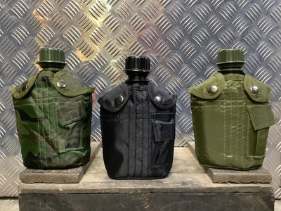 Three military-style water bottles on a metallic surface with a checkered background