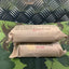 Two wrapped bandages with text on a camouflage-patterned surface