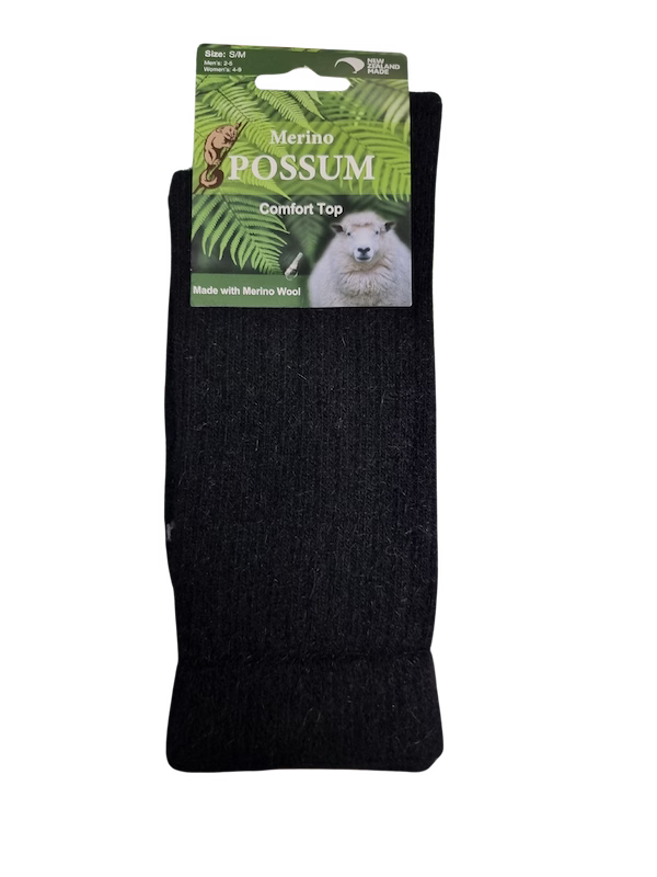 Black merino possum comfort top with a green label featuring a possum image on a white background