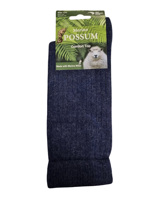 Dark blue socks with a Merino Possum label on a white background