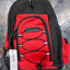 Black and red backpack on a metallic surface