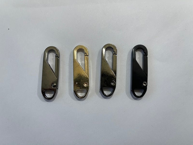 Four metal carabiners in different colors on a white background
