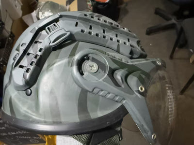 Close-up of a gray helmet with visible branding on a blurred background