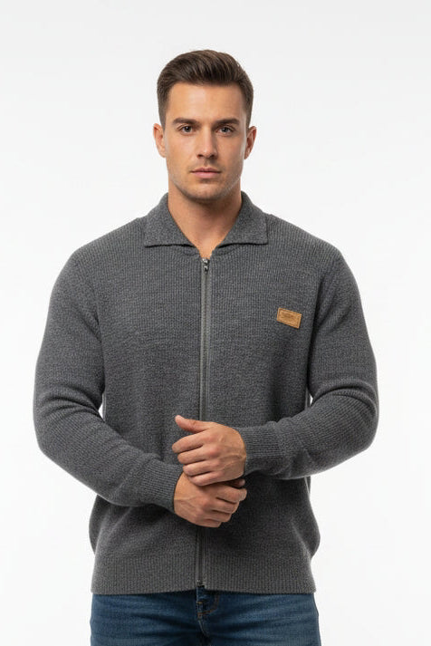 Man wearing a gray zip-up sweater with a brand logo on a white background