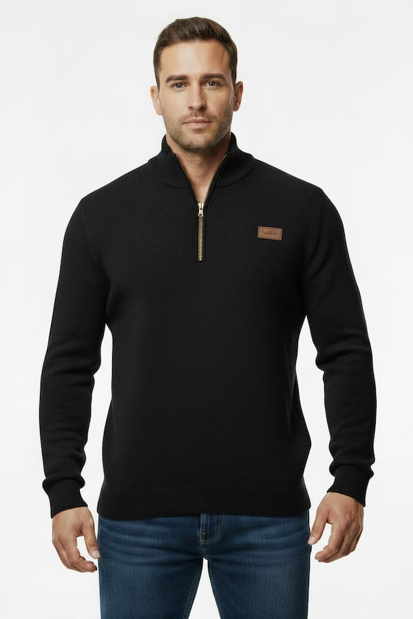 Man wearing a black zip-up sweater with a brown patch on a white background