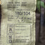 Fabric label with size and care instructions on a camouflage background