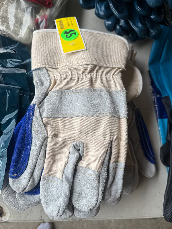 Pair of beige and gray work gloves with a yellow tag on a surface.