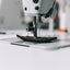 Close-up of a sewing machine needle in action with a blurred background
