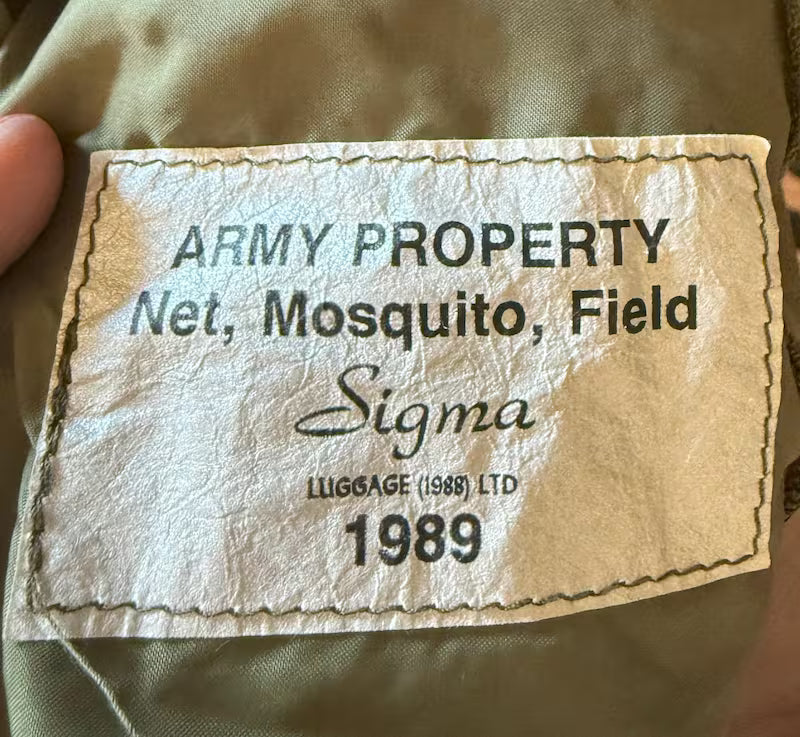 Vintage Army property label on a military uniform, featuring the brand 'Sigma'.