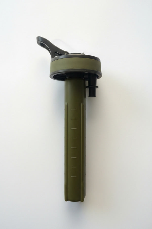 An olive green tactical water filter straw with a black flip-top lid and measurement markings on the handle, shown against a plain white background.