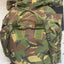 Camouflage backpack on a light gray surface