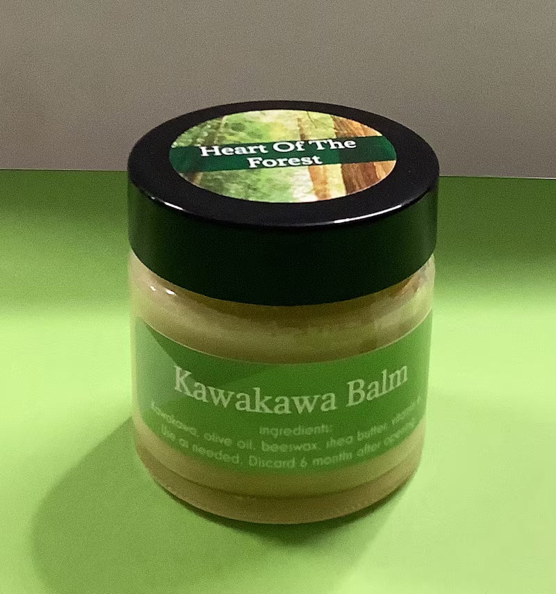 Jar of Kawakawa Balm with a green label on a green surface