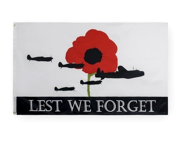 Flag with a red poppy, airplanes, and 'Lest We Forget' text on a white background