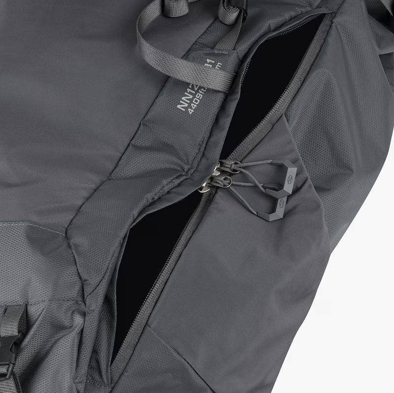 Close-up of a gray backpack with a visible brand label on a white background