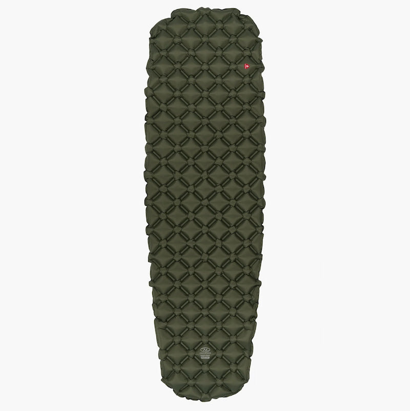 Green quilted sleeping pad on a white background