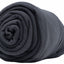 Rolled-up dark gray blanket on a white background