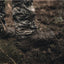 Camouflage pants and boots on a person standing in a natural setting