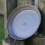 Two gray plates leaning against a wooden post with 'Trailmate' branding.