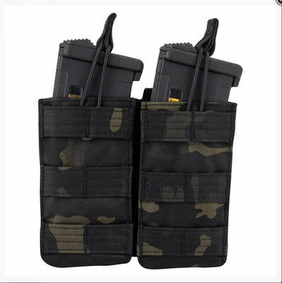 Black and green camouflage magazine pouch with two gun magazines on a white background