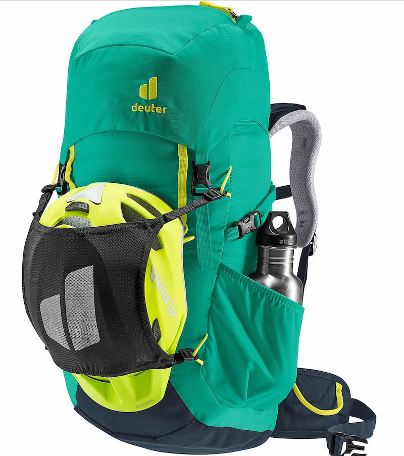 Green hiking backpack with helmet and water bottle on a white background