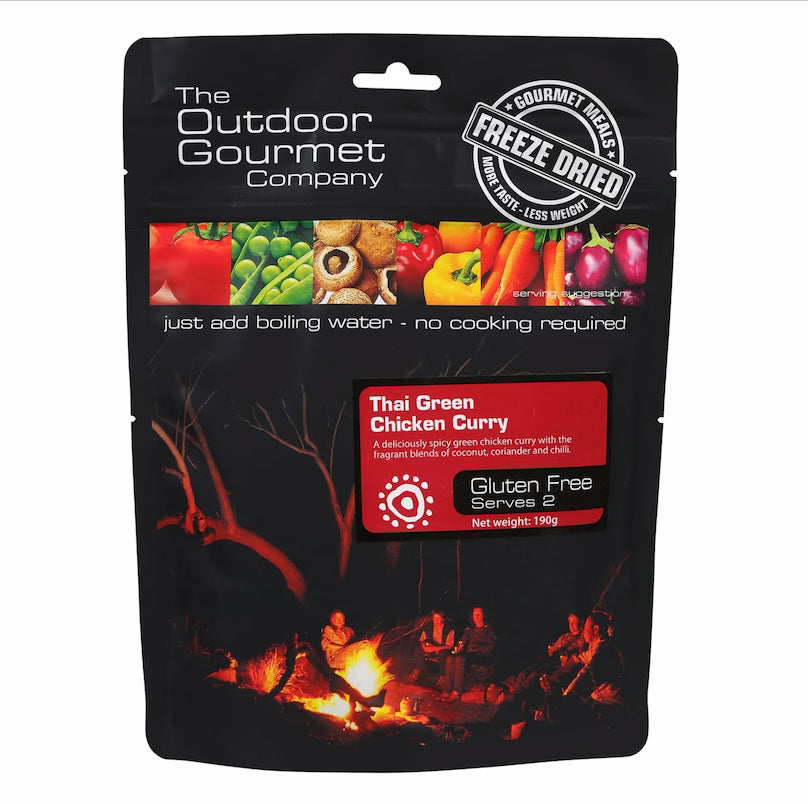 Package of Thai Green Chicken Curry from The Outdoor Gourmet Company with a campfire scene on a white background.