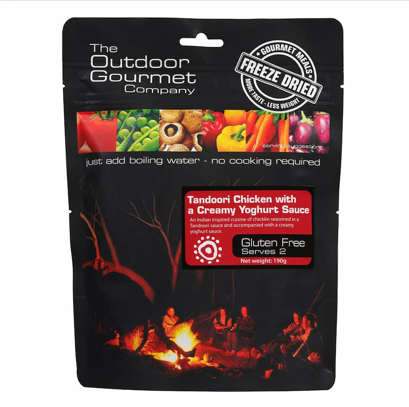 Packaging of The Outdoor Gourmet Company's freeze-dried food product with a campfire scene on a white background.