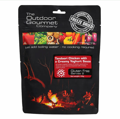 Packaging of The Outdoor Gourmet Company's freeze-dried food product with a campfire scene on a white background.