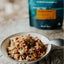 Pasta dish in a bowl with a package in the background