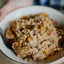 Close-up of a bowl containing a mixture of ground meat and vegetables.