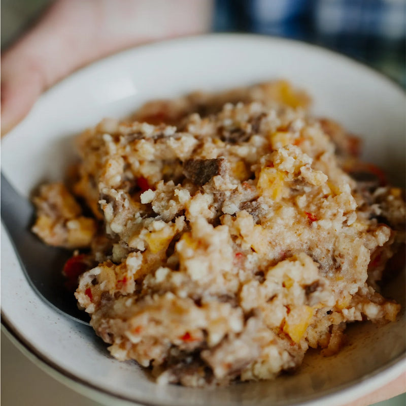 Close-up of a bowl containing a mixture of ground meat and vegetables.