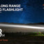 Hunting flashlight advertisement with a person holding a flashlight and a starry night sky.