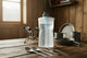 White hydropak bottle on a wooden table with a mountain view in the background