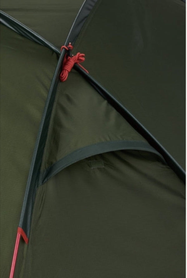 Close-up of a green tent with red ropes and poles.