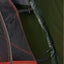 Close-up of a tent with red, black, and green sections.