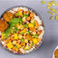  bowl of rice with vegetables and chickpeas on a gray background