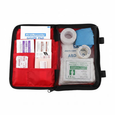 An open first aid kit pouch with red fabric pockets and a clear front compartment showing medical supplies including gauze pads, bandages, and a sterile comb.