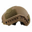 Tan tactical helmet with a green patch on a white background