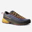 A single La Sportiva trail running shoe shown from a three-quarters angle against a light gray background. The shoe features a dark gray and navy blue mesh upper, mustard yellow laces, a yellow midsole, and red accents on the outsole and heel pull tab.