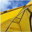 Yellow tent with a clear mesh door against a blue sky