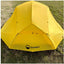 Yellow tent with DOMEX logo on a grassy background