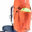 Orange hiking backpack with a helmet on a white background