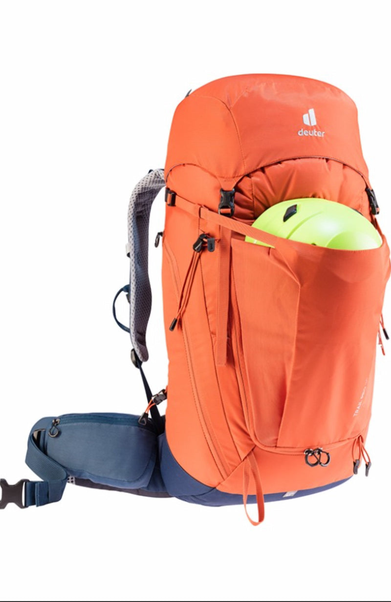 Orange hiking backpack with a helmet on a white background