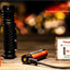 Black flashlight with batteries and power indicator on a wooden surface
