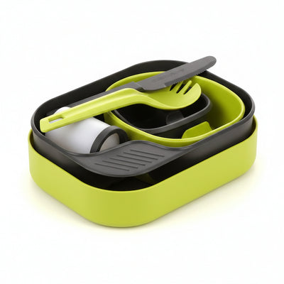 Set of green and gray cutlery in a container on a white background