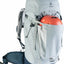 Gray hiking backpack with orange helmet inside on a white background