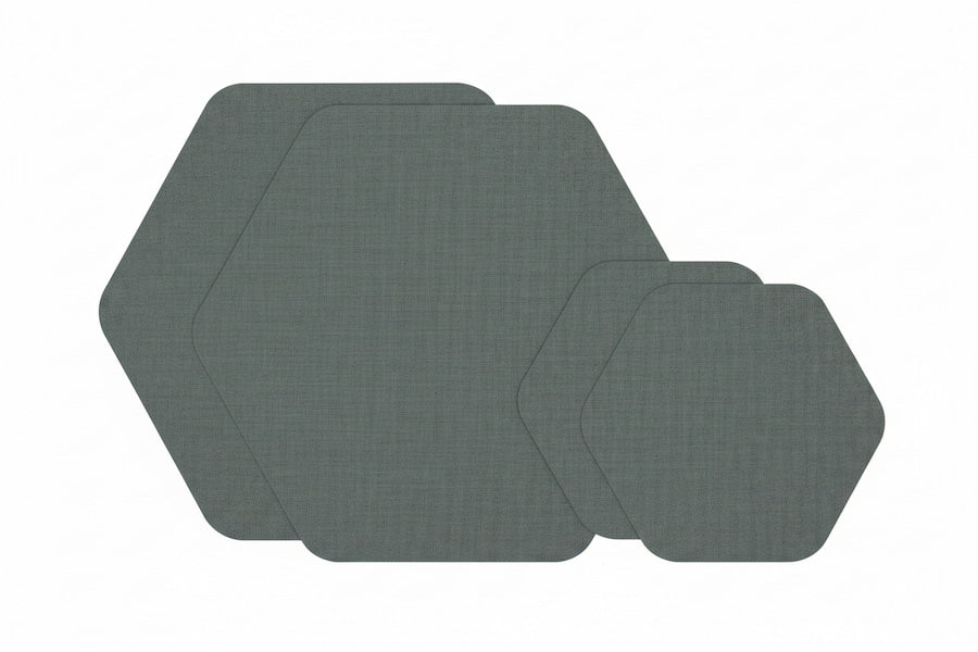 Four hexagonal placemats in a dark gray woven fabric, arranged in a cascading stack on a solid white background.